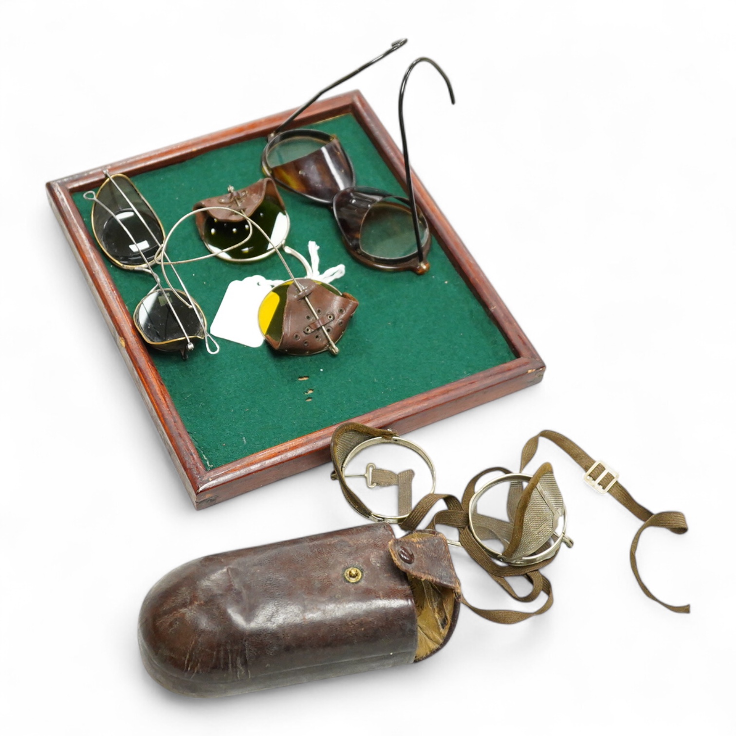 A pair of early 20th century Theodore Hamblin safety goggles with mesh wire sides, with original case, a pair of prescription mesh sided safety glasses, a pair of faux tortoiseshell safety glasses and a pair of Willson,